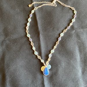 Silver necklace with blue stones.